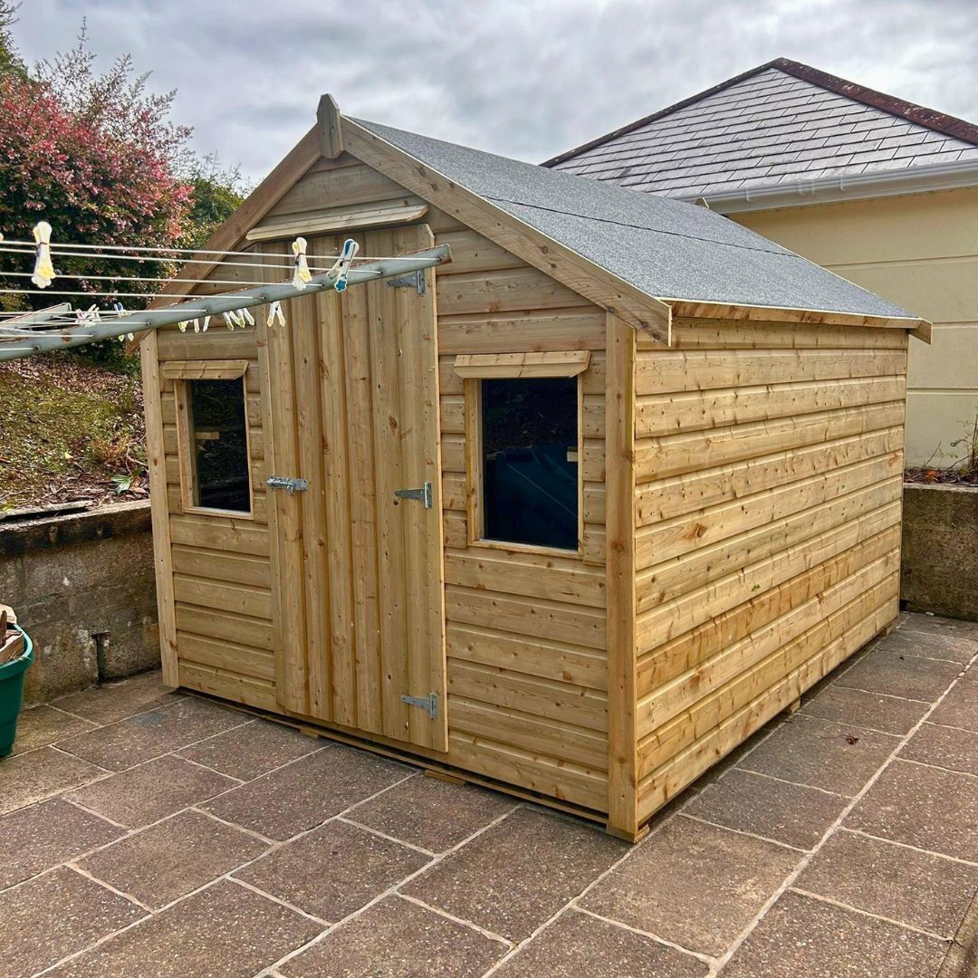 10ft x 8ft Timber Garden Shed placed on concrete slabs at the rear of a home
